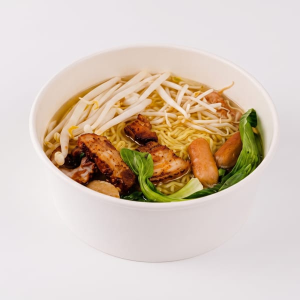 Noodle soup with roasted pork, sausages, bean sprouts, and bok choy in a white bowl.