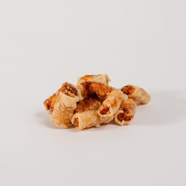 A heap of crispy, golden-brown fried spring rolls.